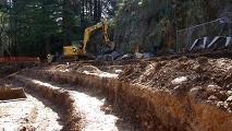 Grading and trenching continues for bench seating.
