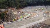Wide view of amphitheater, workers doing various finishing work
