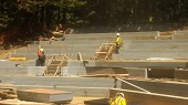 Workers building wood forms for concrete stair pours.